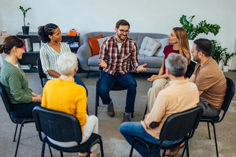 a man speaking in front of a group about alcohol liver damage
