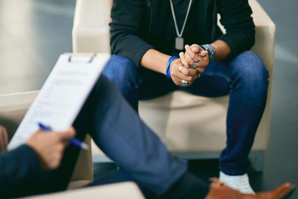 Individual consulting a therapist about meth and glass use