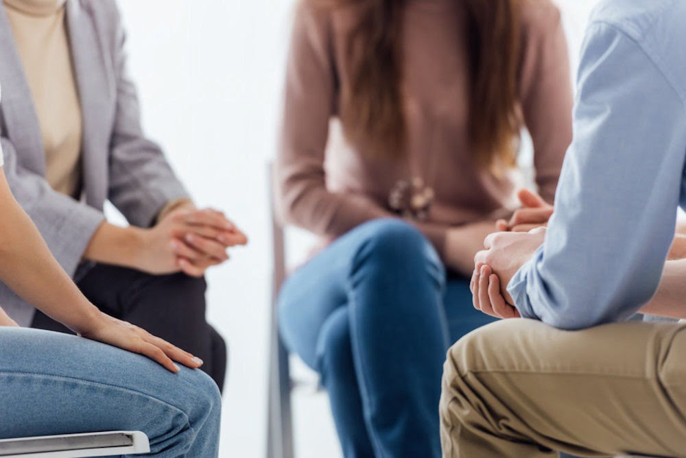 Group therapy session with a therapist discussing gateway drug addiction