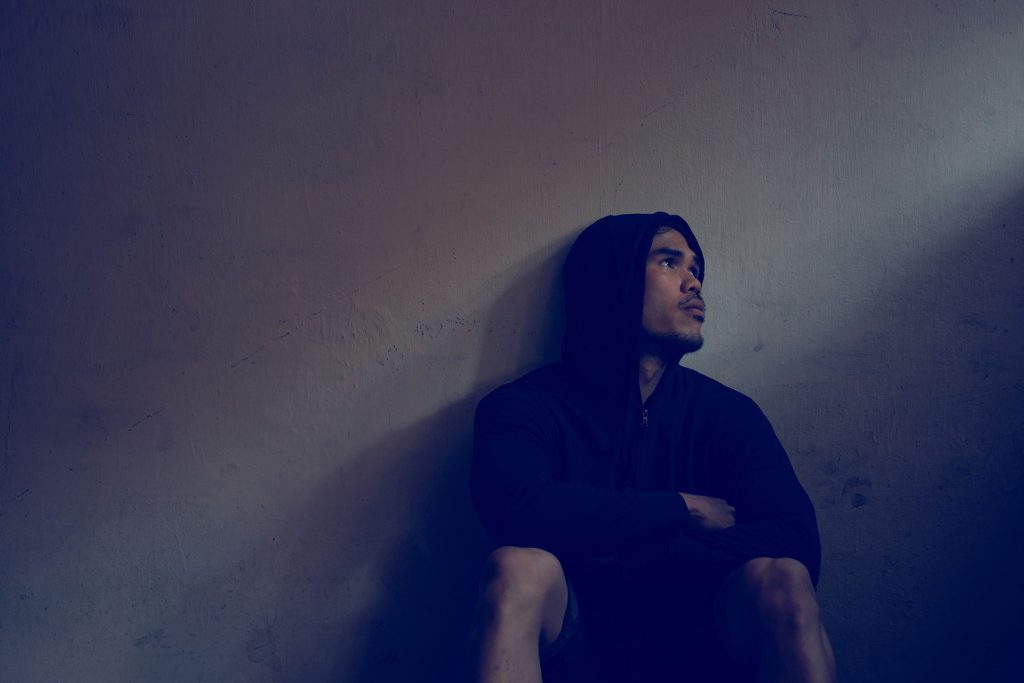 Man enduring severe heroin withdrawal symptoms in detox setting