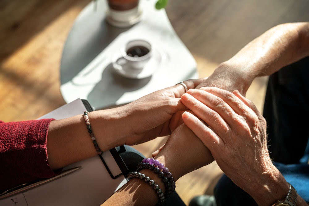 Partners holding hands, representing care during long-term Adderall challenges