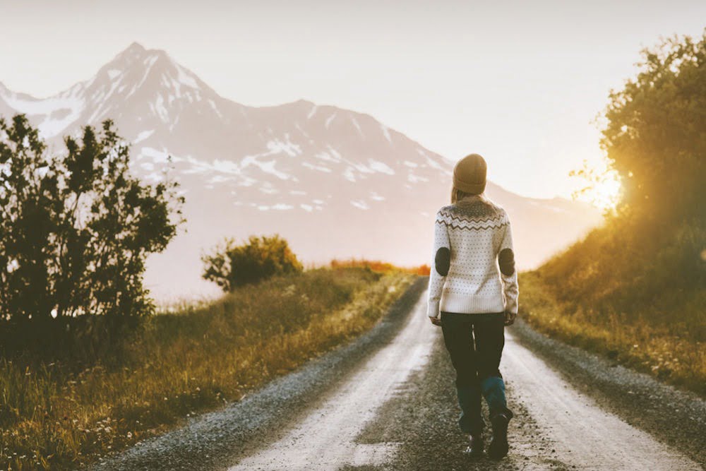 A woman enjoying holistic therapy outdoors, connecting with nature and inner peace