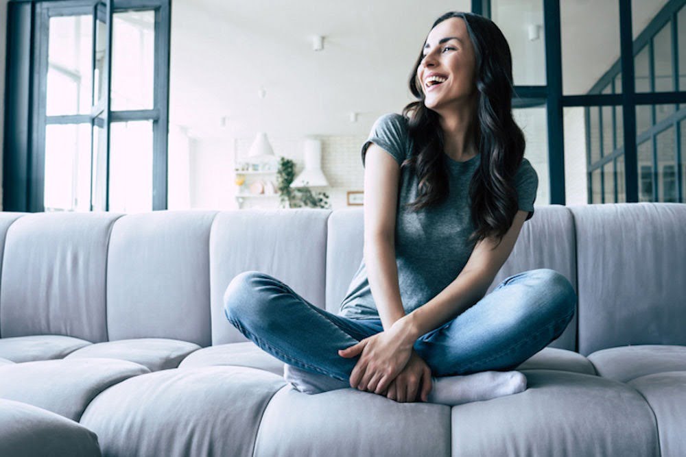 Woman laughing alone, showing effects of schizophrenia on the brain