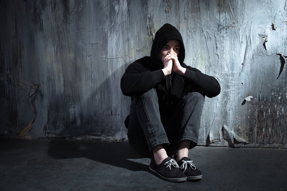 Man in hoodie overdosing on fentanyl
