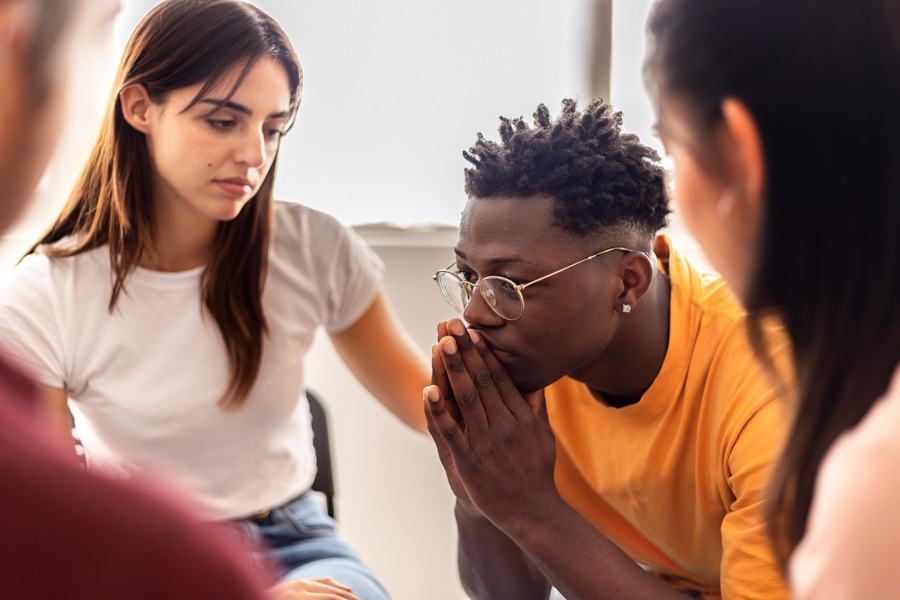 Group therapy session discussing early warning signs of relapse