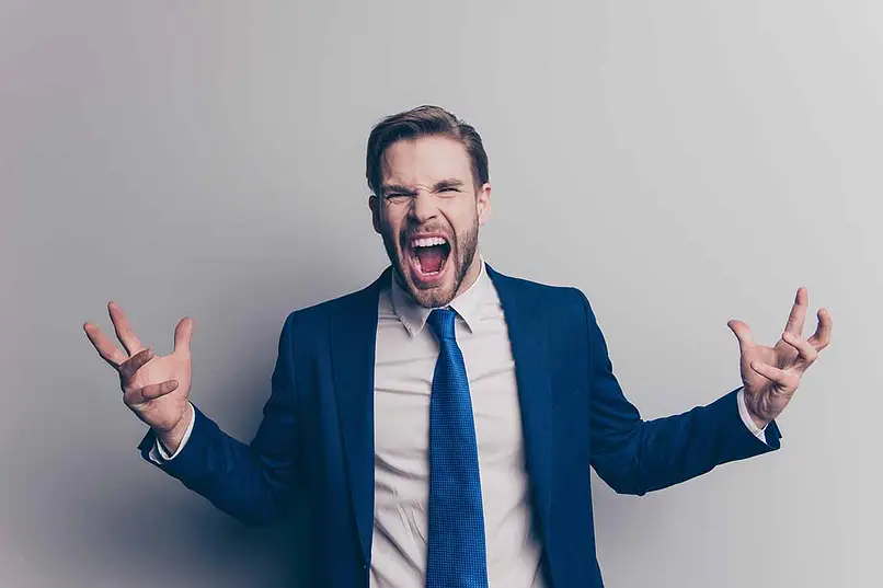 a man with OCD in a suit with his mouth open