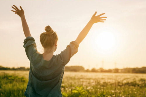 woman enjoying a peaceful sunset during inpatient drug rehab recovery