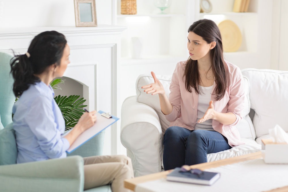 Woman discussing drug treatment with her counselor about highest drug use by state