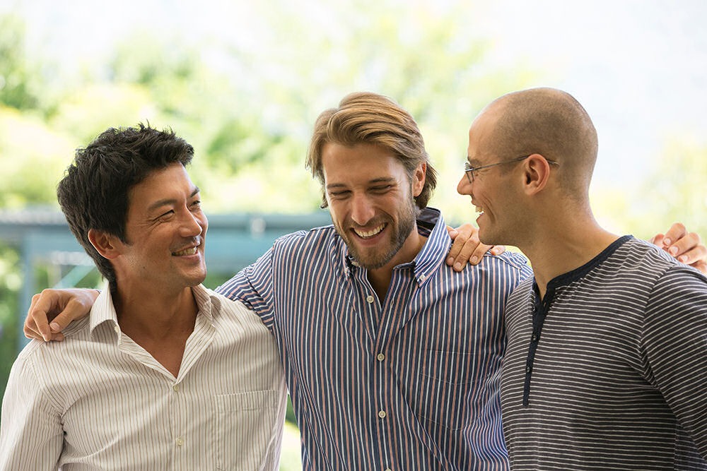 Relieved men undergoing the 12 Promises of AA