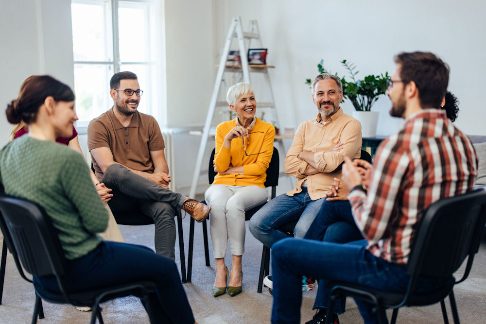 People in therapy learning about the 12 Promises of AA