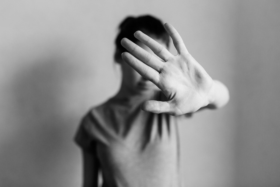 Woman covering her face, showing what meth does to your face