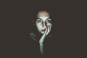 a woman in the dark experiencing difficulty concentrating caused by Ambien use