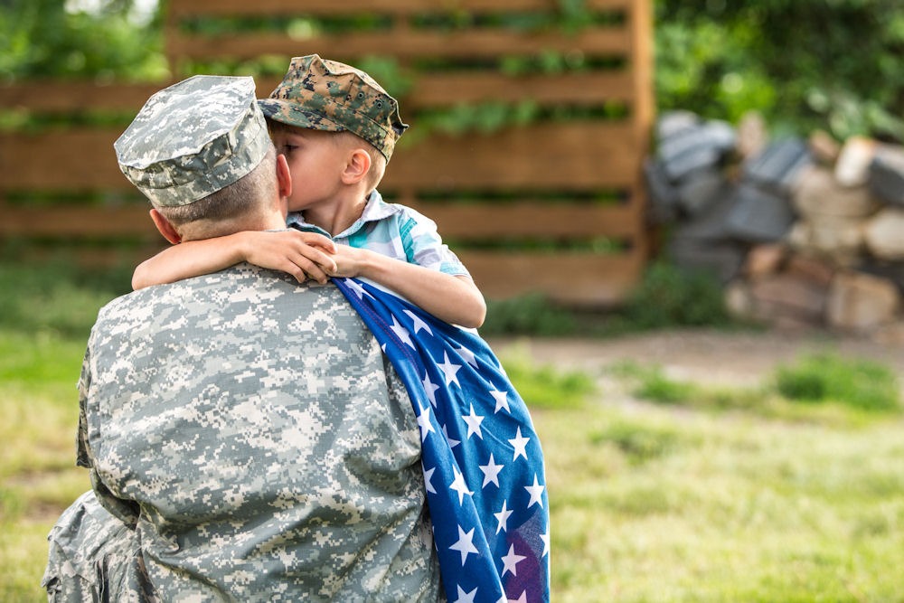 Active duty service member hugging their child before entering Integrity Recovery Treatment Center
