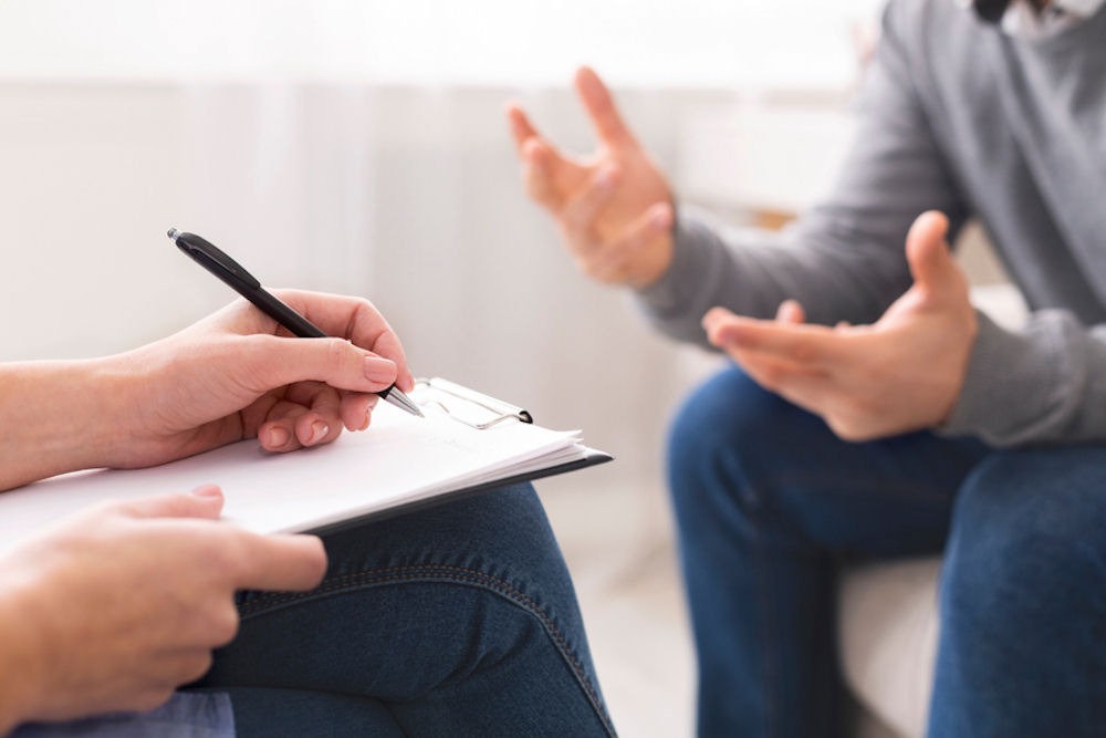 a man in therapy for addiction and mental health
