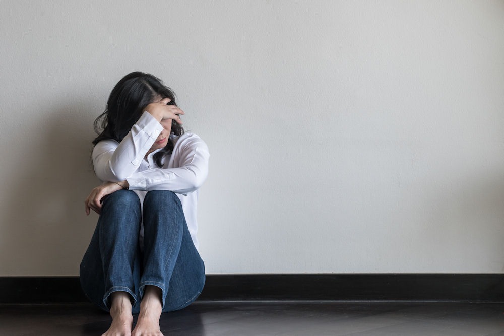 A woman experiencing symptoms from mixing anxiety medication and alcohol