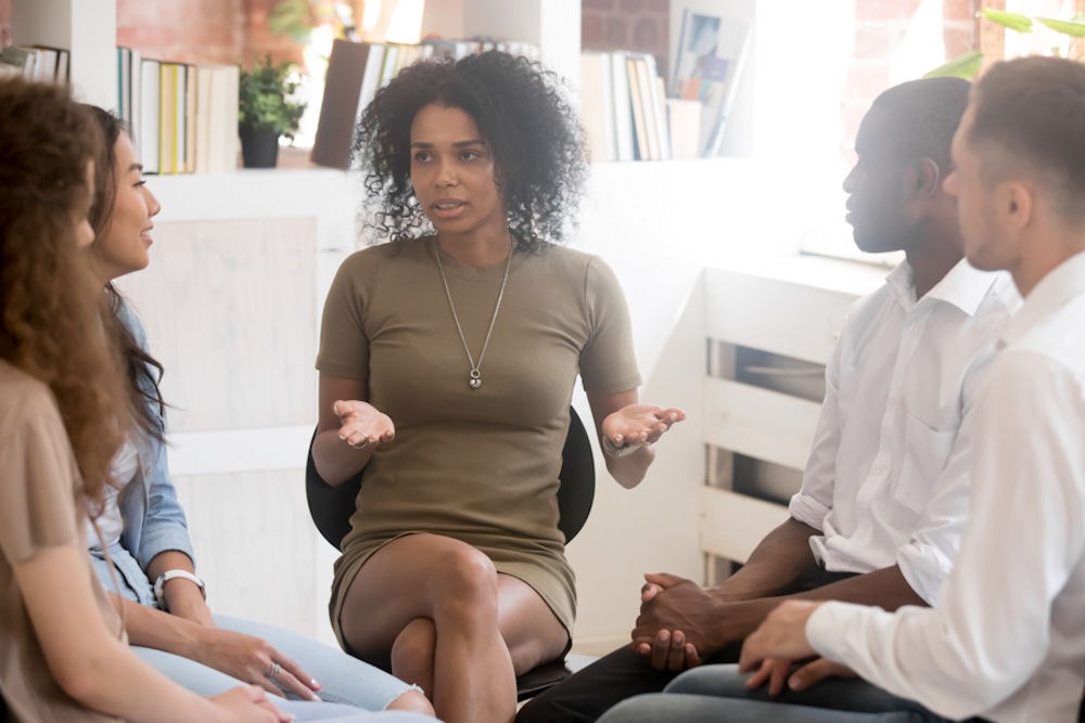 Woman speaking during a group therapy session on evidence‑based addiction treatment