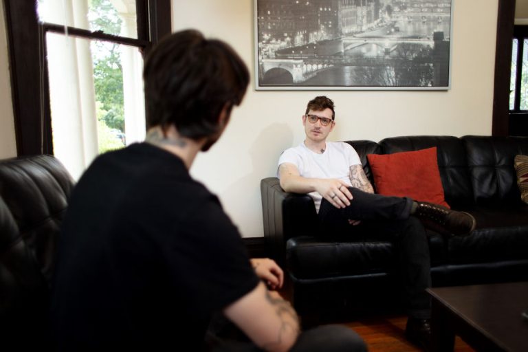 Individual sharing their experiences at an aftercare rehab program