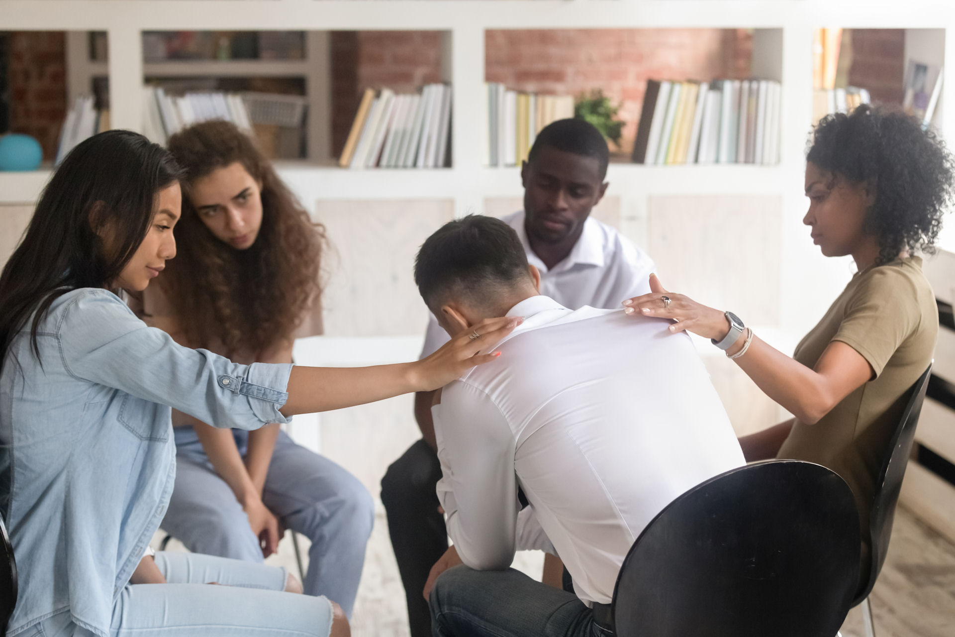 people offering comfort to each other in group therapy in Medford, Oregon
