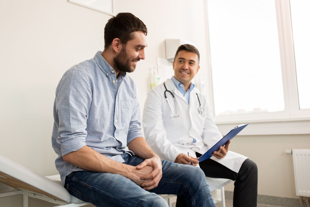 man speaking to his doctor about the connection between ADHD and alcohol