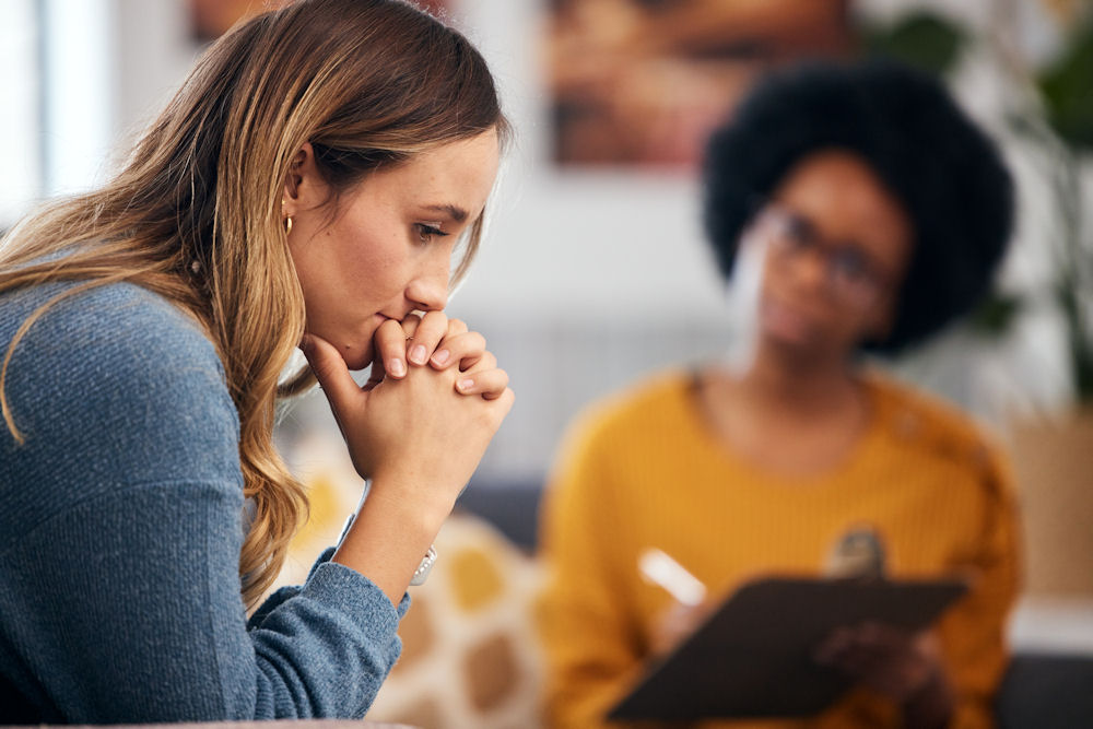 woman deep in thought during therapy session for childhood trauma