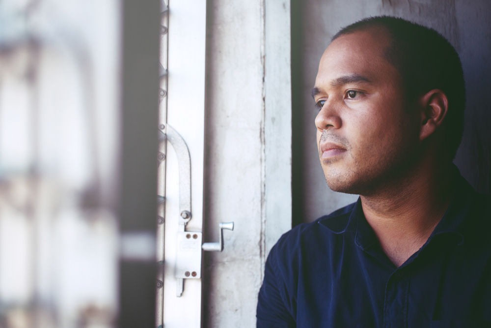 a man staring at window