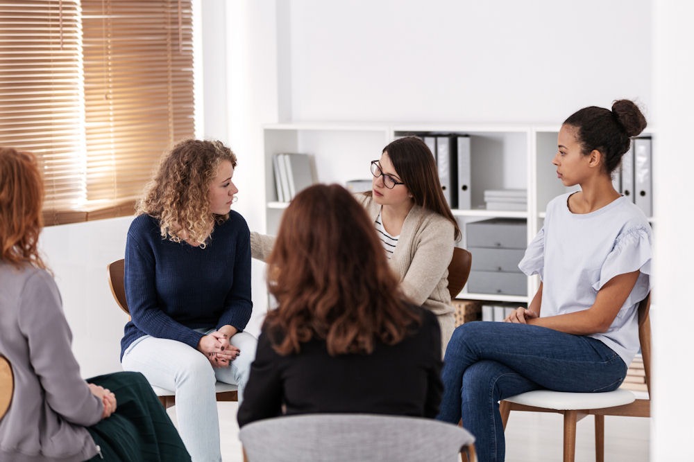 Group therapy session focused on recovery activities that encourage peer support, communication, and shared healing.