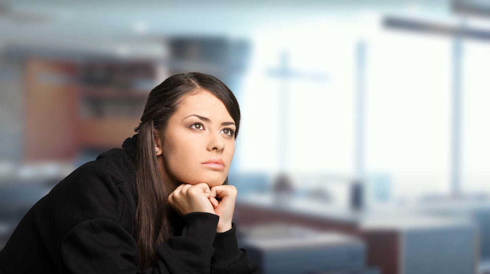 Woman experiencing high functioning anxiety while appearing calm and focused in a professional setting