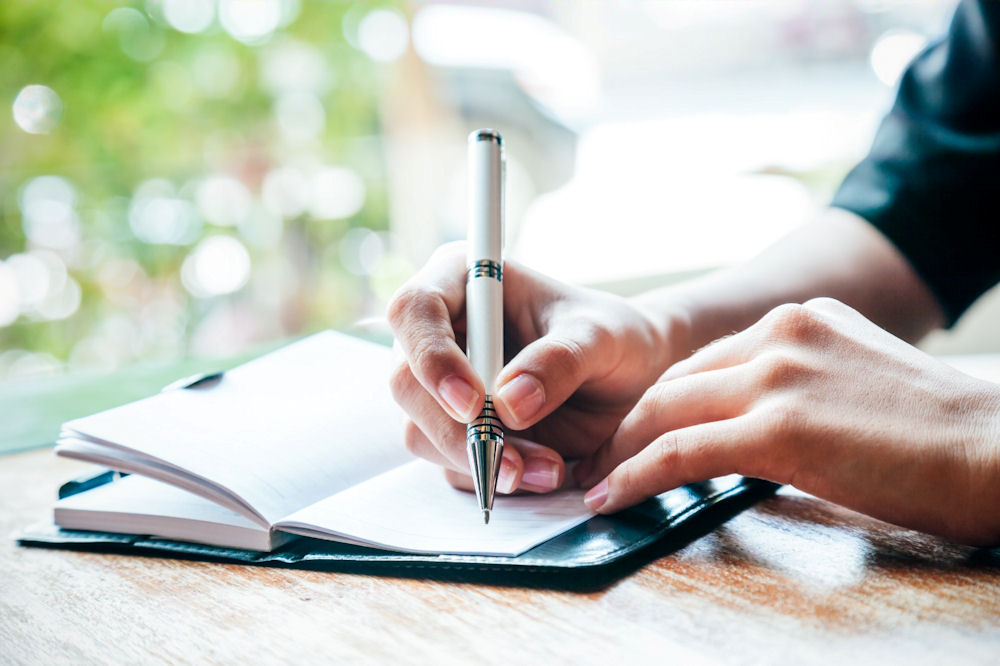a person writing in their journal