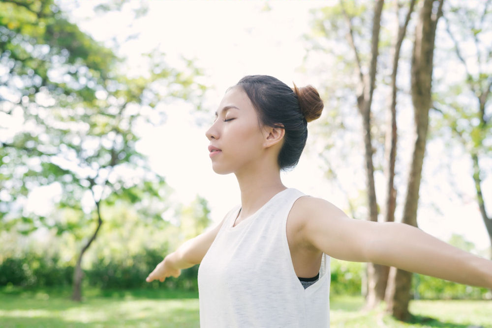 a woman stretching outside in nature