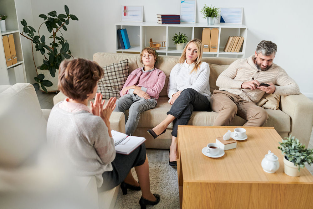 Family counseling session showing parents and a teen discussing family support in residential treatment.