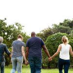 a group of individuals holding hands