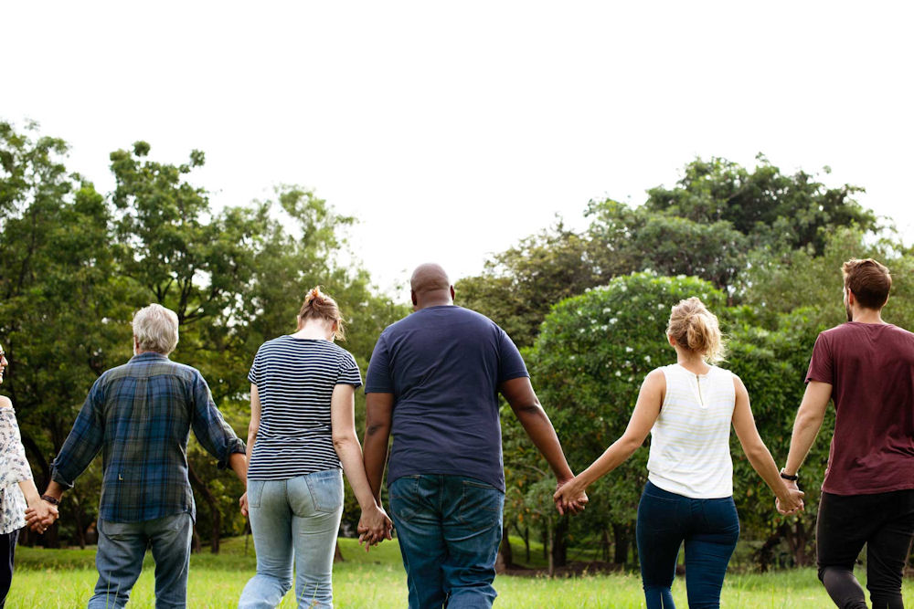 a group of individuals holding hands
