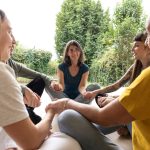 a group of women sitting in a circle