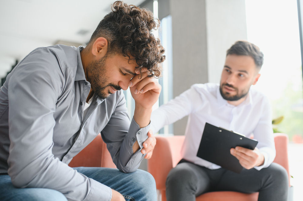 a-man-being-comforted-in-therapy-session
