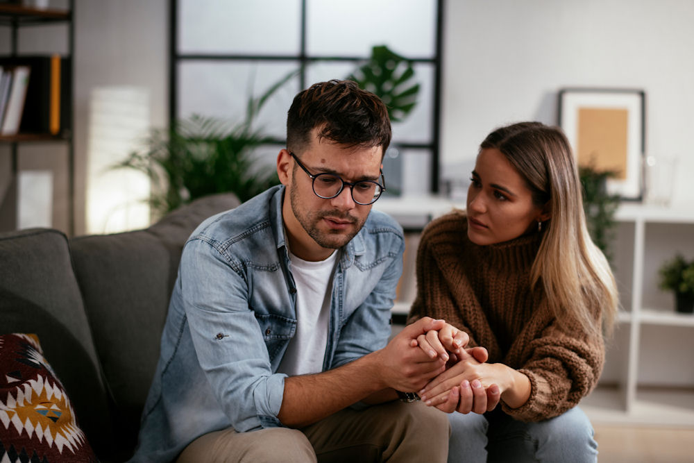 a-woman-comforting-a-man-in-therapy