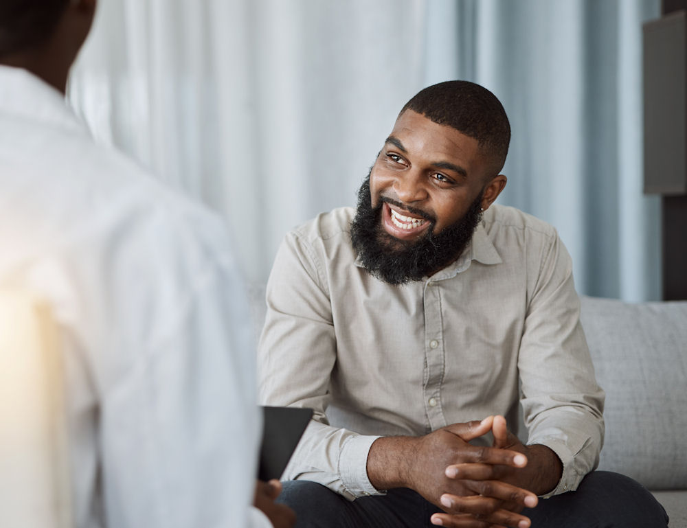 a-man-smiling-in-therapy-session